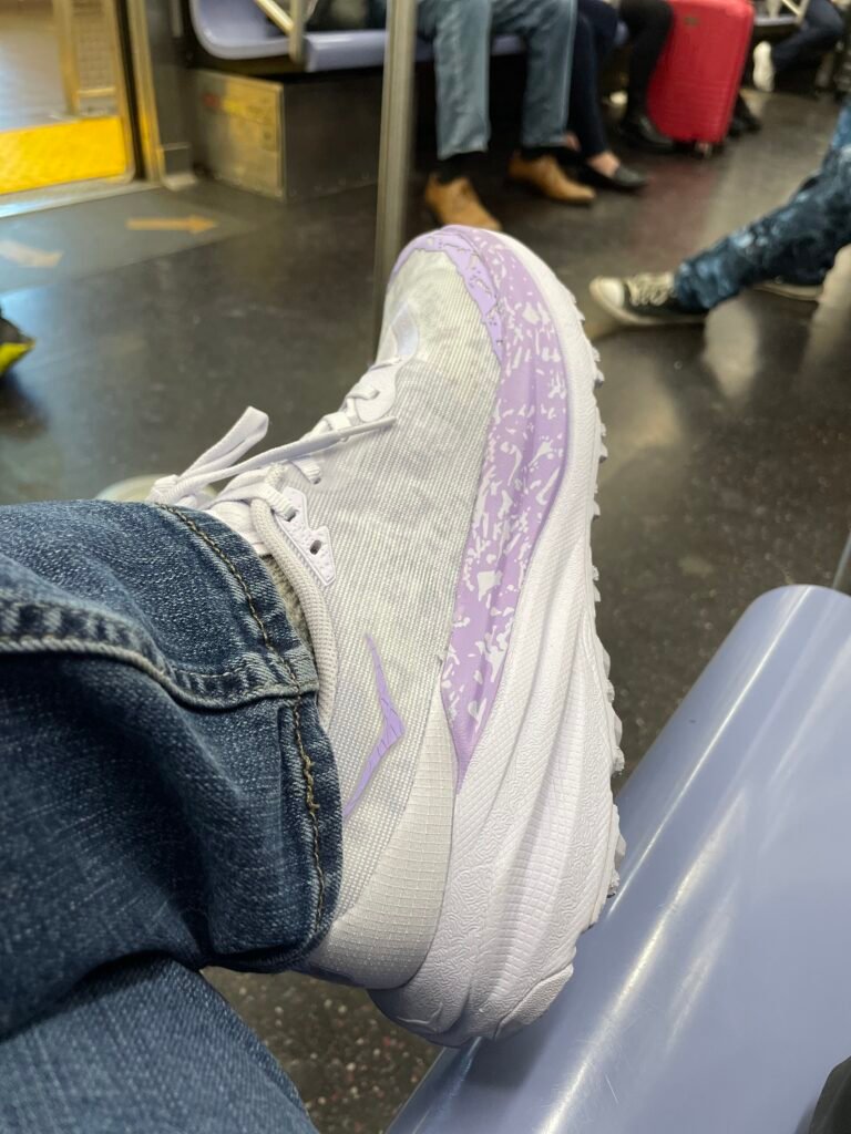 Hoka Speedgoat on a NYC Subway